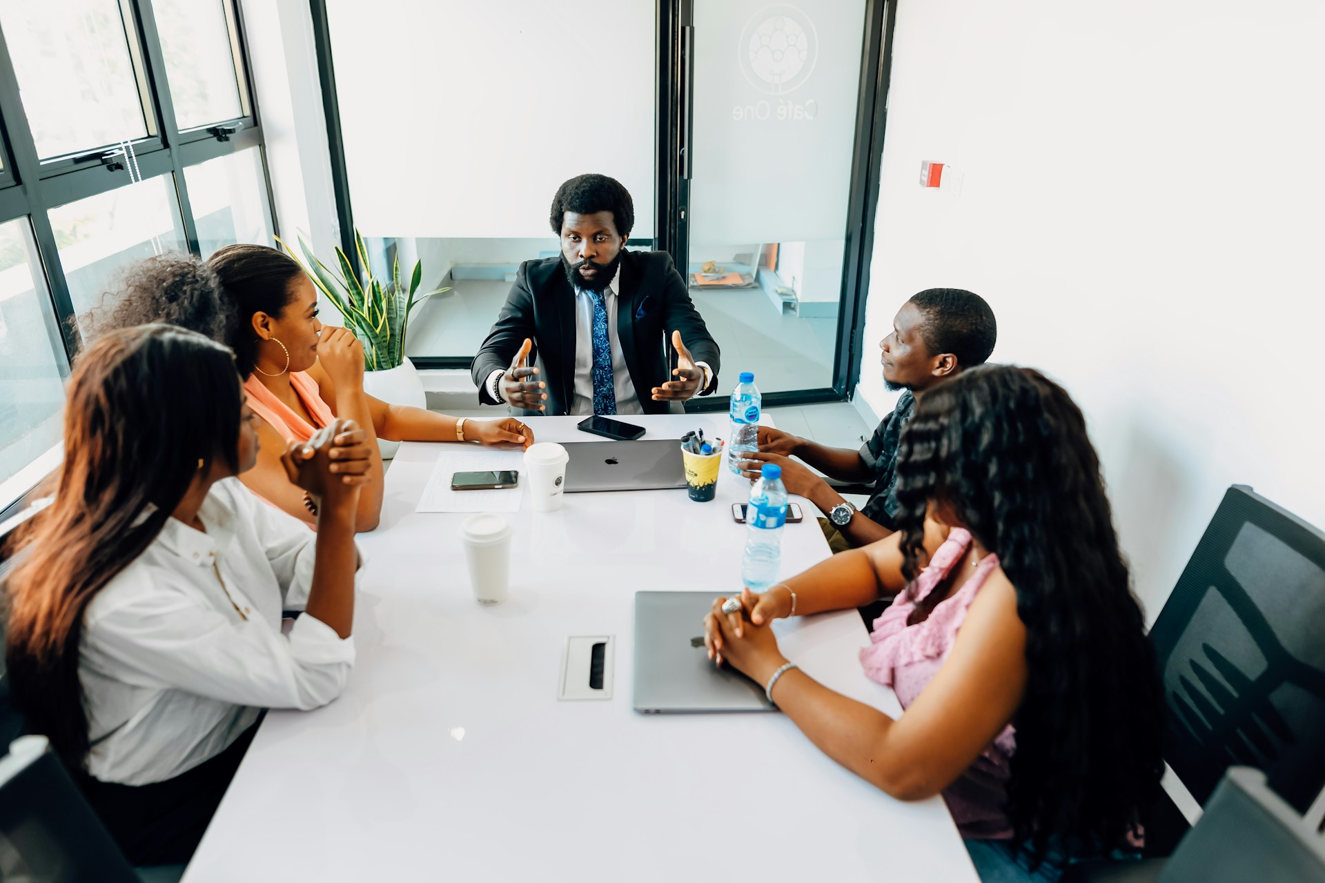 A group of people sitting around a white table